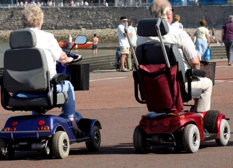 2 elderly people on Mobility scooters