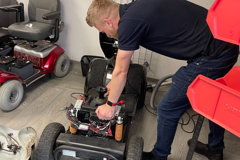 Man repairing a mobility scooter 