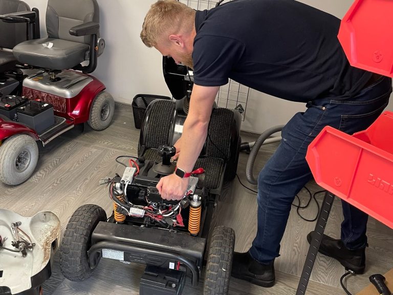 Man repairing a mobility scooter 